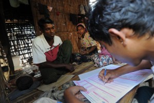 A Muslim man (left) answers questions during a census taking in the village of Barasa. Photo by AFP.