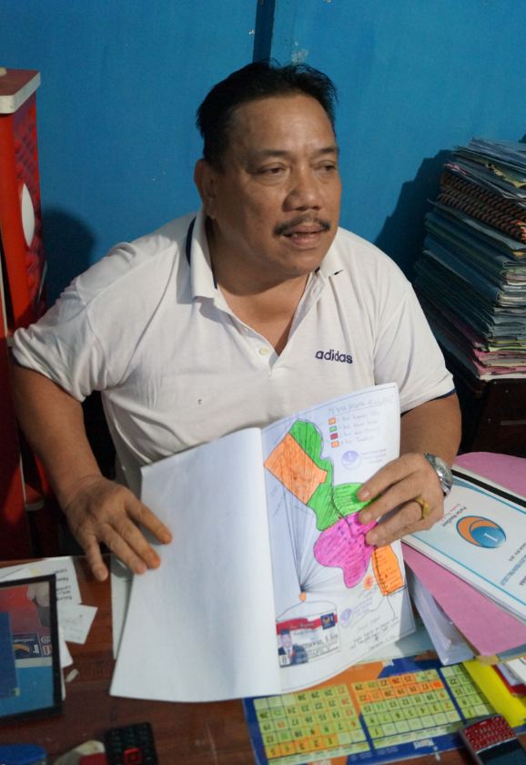 Bapak Darmawan, Nasdem candidate for the local parliament in Kapuas district, Central Kalimantan, with a map outlining his attempts to reach down to voters at the village level. Photo: Edward Aspinall
