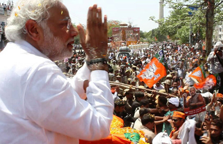 Narendra Modi waves to supporters.