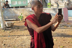 A young monk and smart phone. Photo by Belinda Cranston.