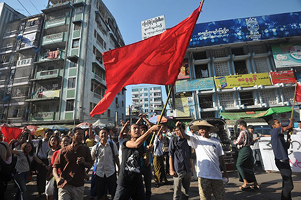 Myanmar student protesters and nationalists shout slogans and wave flags during a demonstration supporting the student protests . Photo by AFP. 