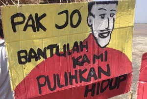 "Pak Jo, help us get out lives back." Photo by Phillip Drake.