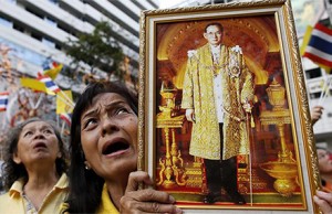 Thai royalist holds a portrait of King Bhumibol Adulyadej. Photo by EPA/ Rungroj Yongrit.