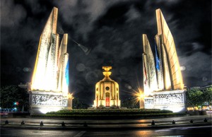 Bangkok's Democracy Monument shrouded in shadow. Photo by Natt Muangsiri on flickr.