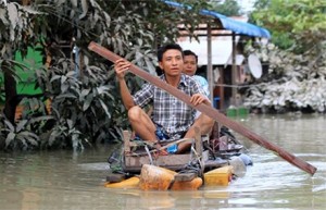 Two men navigate rising waters in Kalay, Sagaing Region Myanmar. Photo by Ministry of Information.