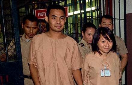 Thai student Patiwat Saraiyaem, 23, left, and activist Porntip Mankong, 26, are escorted by prison security guards after their verdict at the Criminal Court in Bangkok. Photo: AFP.