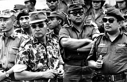 General Suharto (second from left) and other army officers attend the funeral of their slain comrades in 1965.