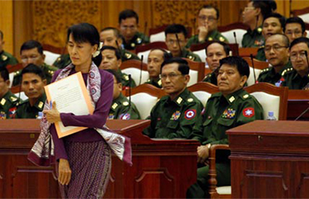 Aung San Suu Kyi walks to take her oath in parliament in Burma