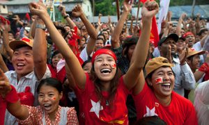 National League for Democracy (NLD) supporters celebrate their victory in parliamentary elections outside party headquarters on April 1, 2012 in Yangon, Myanmar. Photo by Paula Bronstein/Getty Images.