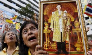 Thai royalist holds a portrait of King Bhumibol Adulyadej. Photo by EPA/ Rungroj Yongrit.