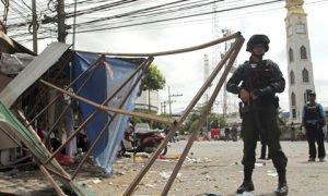 Thai soldiers and police officers at the scene of a bomb attack in Pattani province, southern Thailand Photo: EPA.