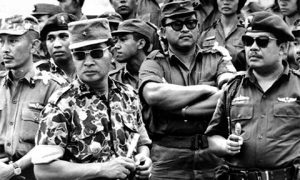 General Suharto (second from left) and other army officers attend the funeral of their slain comrades in 1965.